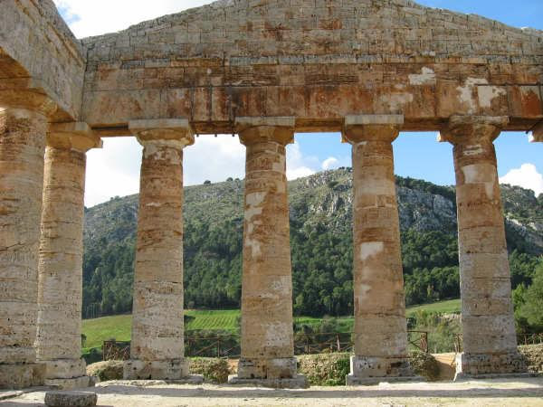 Segesta is a beautifully preserved Ancient Greek temple set amid green fields in Sicily.