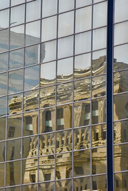 A reflection of an old building from its modern glass in Montreal.