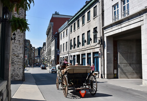 A horse-drawn carriage on an a street in Old Montreal.