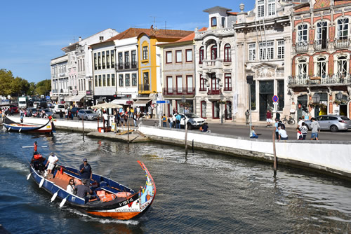 Cruising the canals of Aveiro in 'barcos moliceiros' in Portugal.