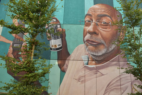 Urban street art  in Porto, Portugal. Self-portrait of a man spray painting.