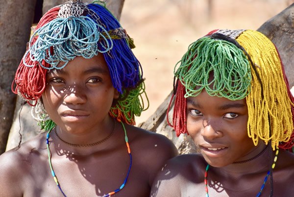 Mudimba girls with beaded wigs, called ena, in Angola.