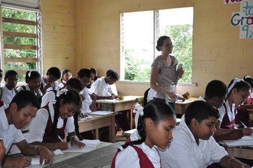 WorldTeach volunteer with students in Guyana