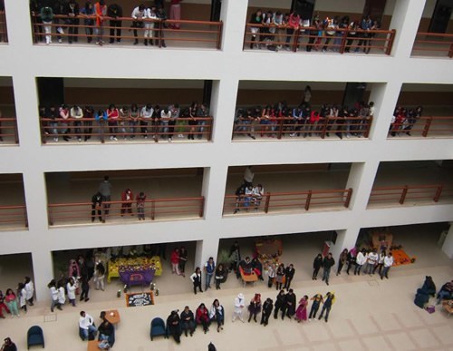 A University in Mexico building with students on balconies and courtyard.