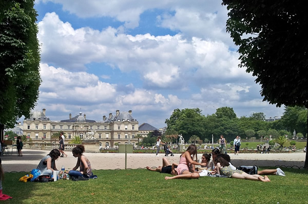 The Jardin de Luxembourg in Paris with students picnicking.
