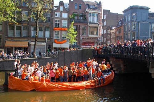 Barge covered in orange during the Amsterdam festival.