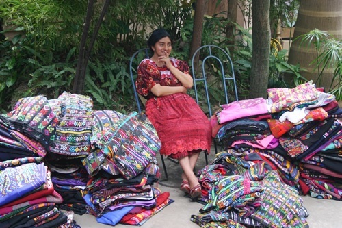 A local artisan selling her colorful textiles in Antigua.