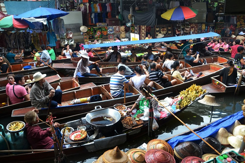Enjoy the floating markets in Thailand.