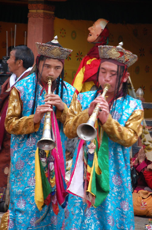 Musicians playing a traditional horn at the Paro festival in Bhutan.