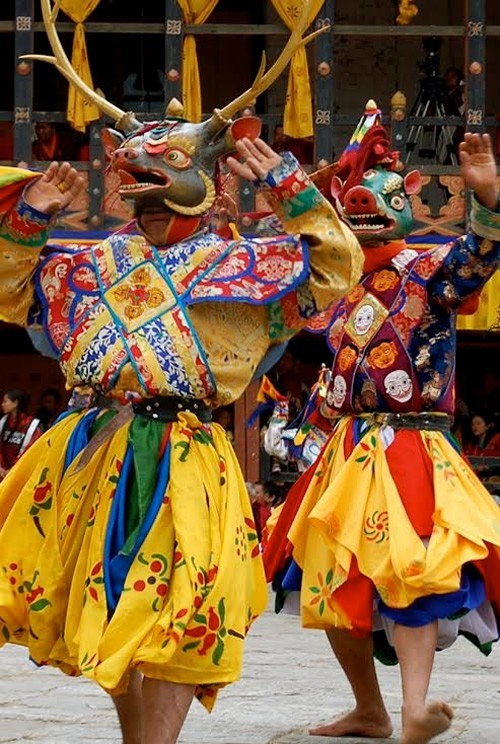 Two costumed men dancing in Paro.