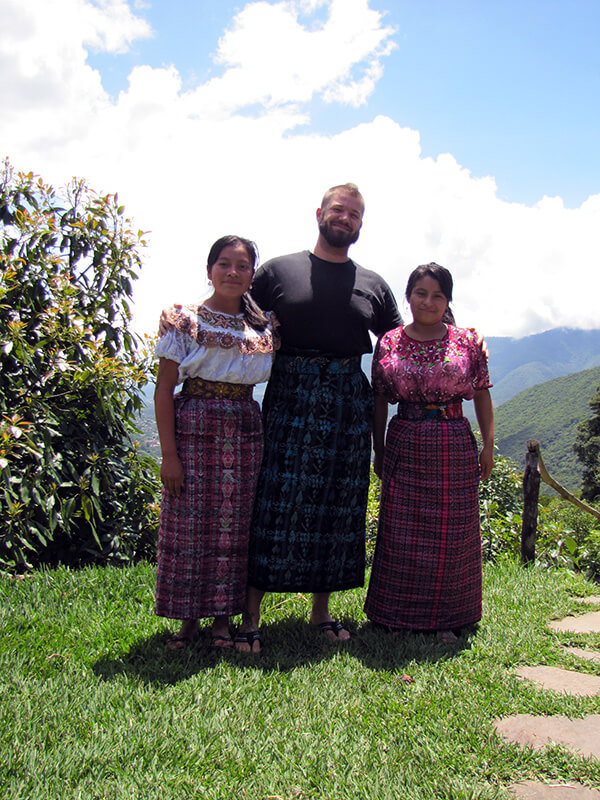 Author is local dress with tow women at the Earth lodge in Guatemala.