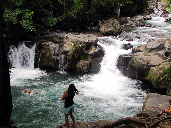 Local swimming hole with rushing water in Costa Rica seen while traveling.