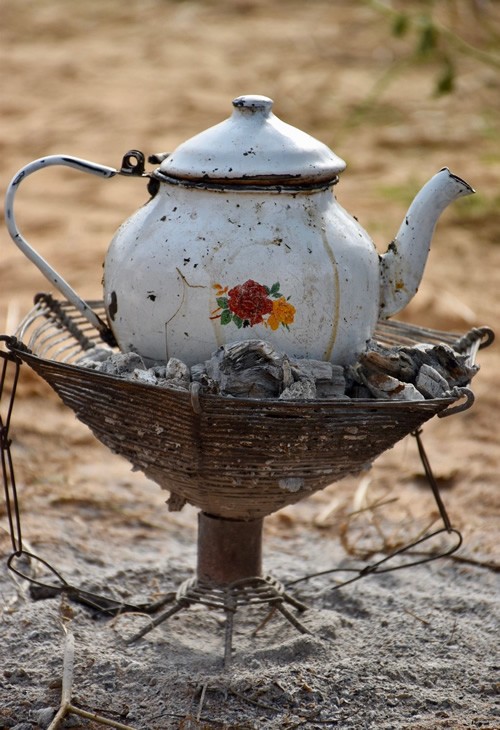Tea session with teapot on charcoal in the Sahel of Chad.