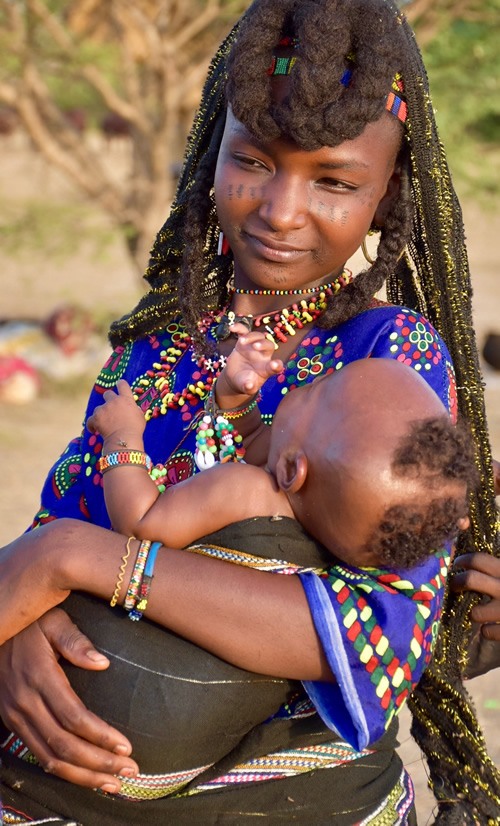 Young Wodaabe mother holding her child.