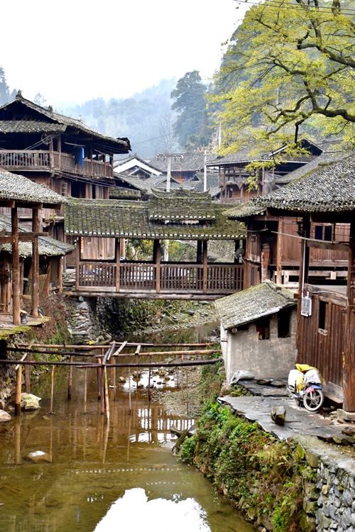 Wooden houses and covered bridge in Dong village in Guizhou Province.