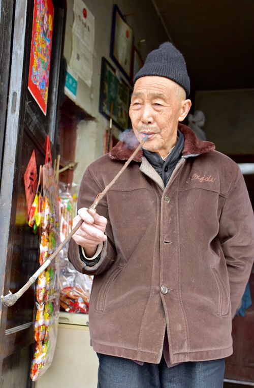 Pipe smoking old Han man in Beizhai in Guizhou Province.