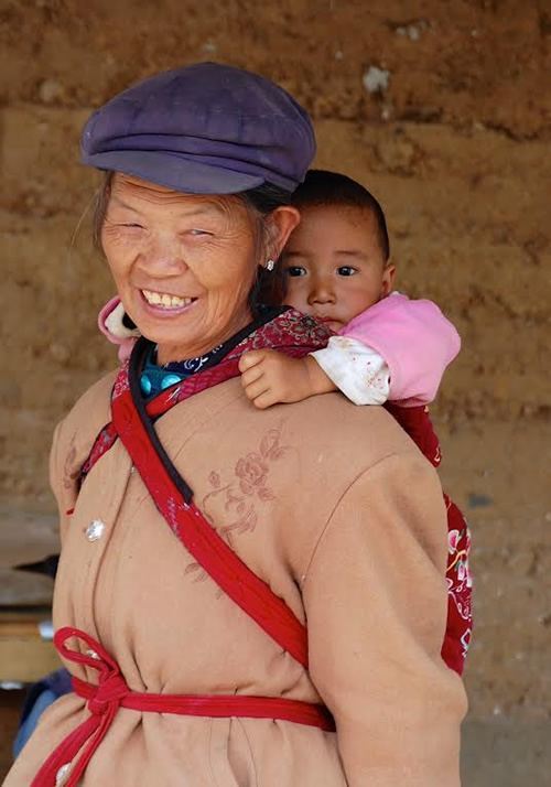 Naxi woman with child on her back.