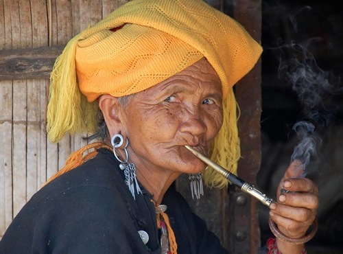 Wa woman smoking a pipe.