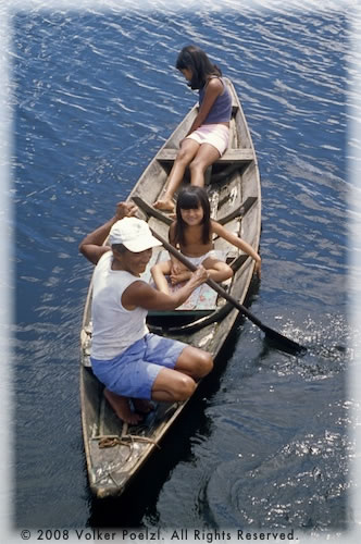 Amazon locals on canoes.