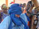 Festival on Niger with man dancing in blue.