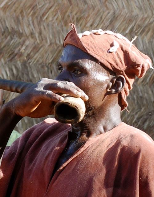 Festival in Mali: Man blowing horn.