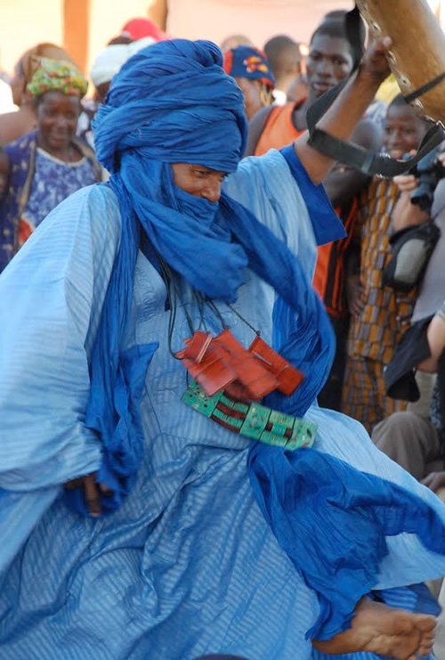 Festival on the Niger: Man dancing dressed in blue.