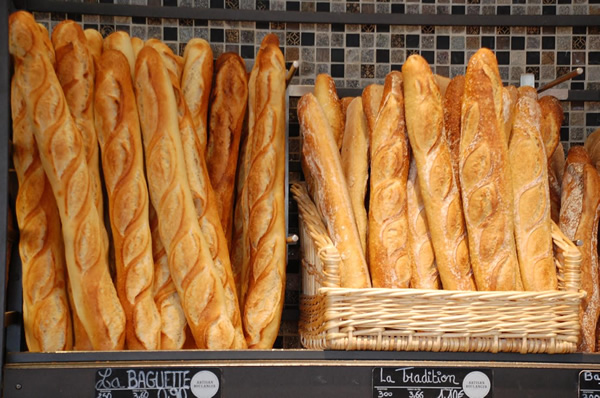 Dozens of fresh French baguettes in a bakery in Paris.