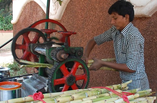 Street vendor selling pressed sugarcane juice.