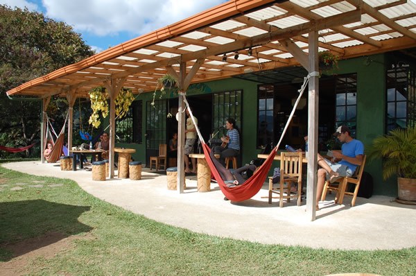 A Guatemalan Eco-Lodge with visitors sitting on the outdoor deck.