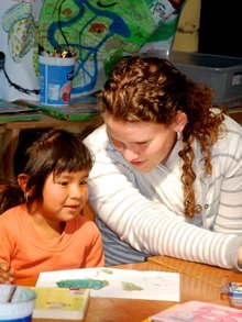 Volunteer teaching a Guatemalan child.
