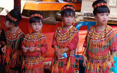 Girls in ceremonial dress for funeral procession.