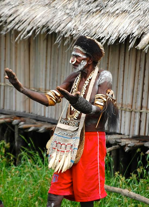 Village chief invites us into a traditional house in West Papua.