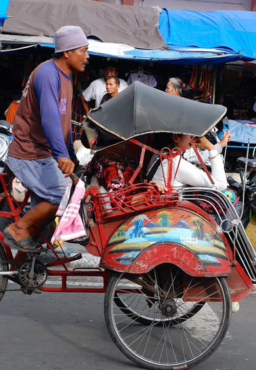 A becak or pedicab driver in Indonesia.