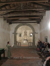 Woman in medieval dress explains the history of the chapel.