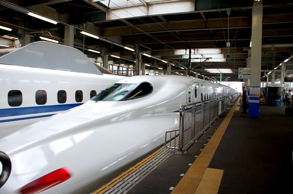 Bullet trains parked at a train station in Japan.