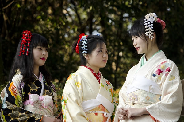 Three young local girls in traditional clothing creates a sense of welcome.