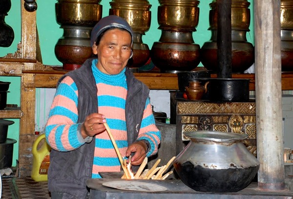 Hostess in the kitchen of her guesthouse in Chilling village in Ladakh.