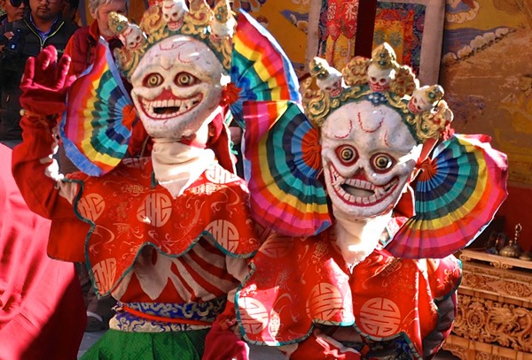 Monks dancing in colorful masks in Ladakh.