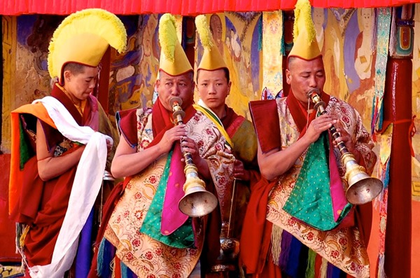 Musicians at festival playing horns in Ladakh.