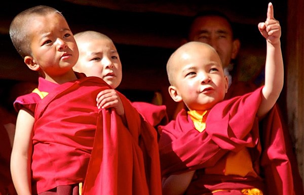 Novices watching the thanka being unfurled in Ladakh.