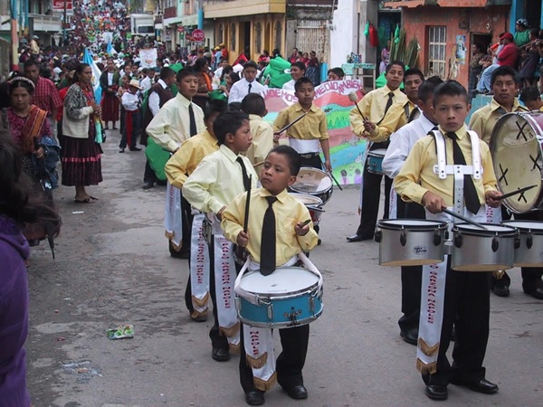 Parade in Almolongo, Guatemala, with children drumming.