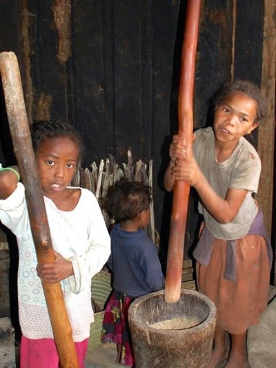 Children pounding rice in Madagascar.