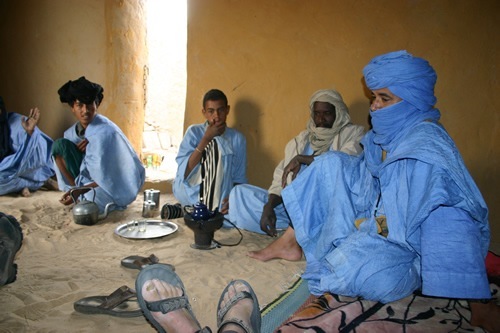 Author sitting with the Tuareg 'Blue Men' of the Sahara Desert with tea.