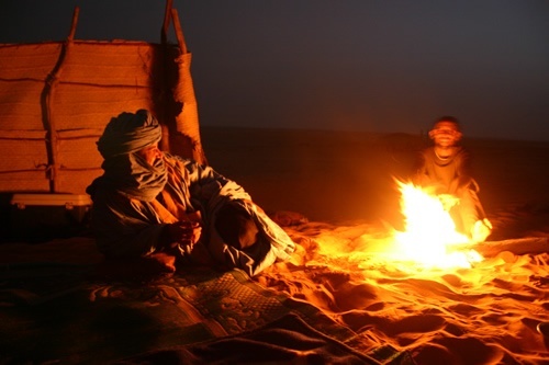 Author next to campfire in the Sahara Desert in Mali with the Tuaregs.