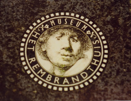 Rembrandt’s face in everywhere, including a house logo in a sidewalk.