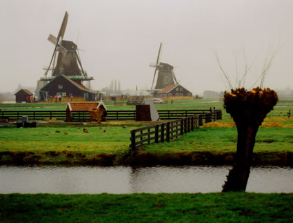The picturesque windmills along the River Zaan, amid the green grass fields.