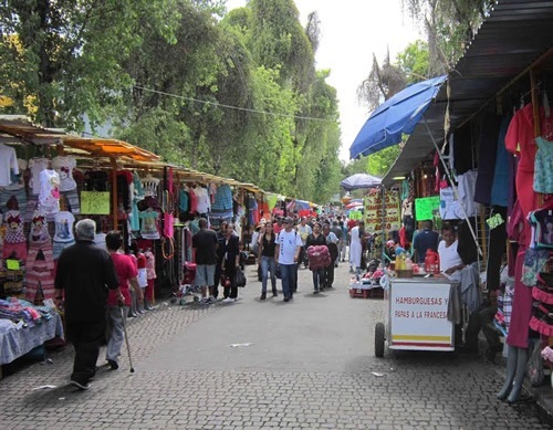 A clothing market on a cobblestone walking street.