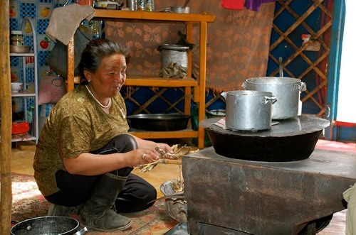 Mongolian woman cooking.