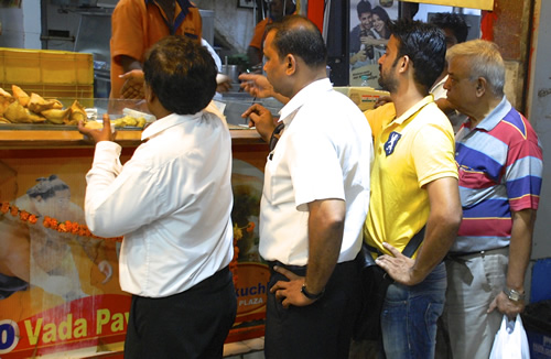Chef and guide Leroy at vada pav stall in Mumbai.