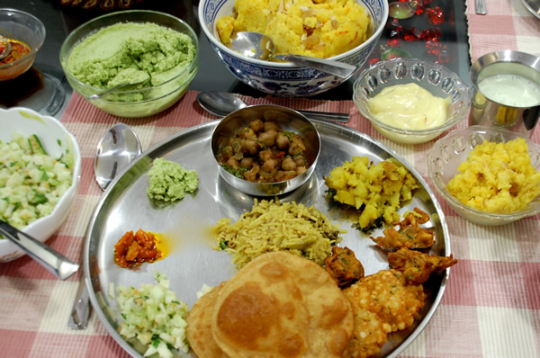 Delicious vegetable thali plate with many foods.